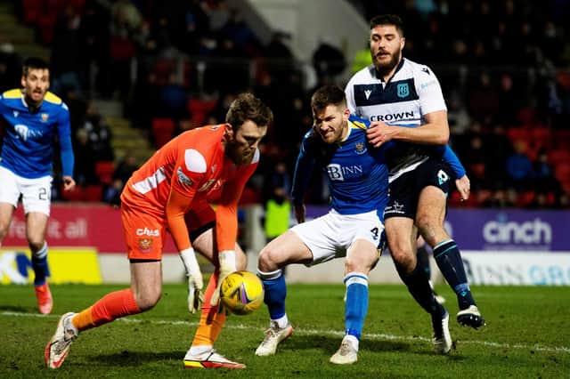 St Johnstone's Zander Clark (L) & Jamie McCart hold off Dundee's Ryan Sweeney (R) during a cinch Premiership match between St Johnstone and Dundee at McDiarmid Park.