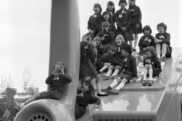 A troop of Brownies sitting on a BT giant telephone at the Glasgow Garden Festival in May 1988.