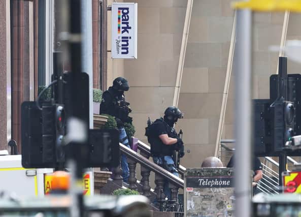 Armed police officers leave the Park Inn hotel in West George Street, Glasgow