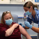 Deputy charge nurse Katie McIntosh administers the first of two Pfizer/BioNTech Covid-19 vaccine jabs to Vivien McKay Clinical Nurse Manager at the Western General Hospital, in Edinburgh.