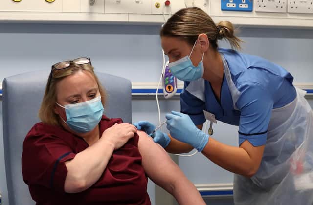 Deputy charge nurse Katie McIntosh administers the first of two Pfizer/BioNTech Covid-19 vaccine jabs to Vivien McKay Clinical Nurse Manager at the Western General Hospital, in Edinburgh.