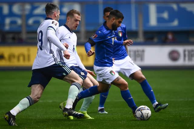Italy's forward Lorenzo Insigne outruns Northern Ireland's defender Michael Smith and midfielder Steven Davis during the FIFA World Cup Qatar 2022 Group C qualification football match between Italy and Northern Ireland on March 25, 2021 at the Ennio-Tardini stadium in Parma. (Photo by MARCO BERTORELLO/AFP via Getty Images)
