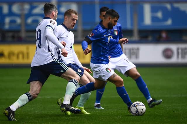 Italy's forward Lorenzo Insigne outruns Northern Ireland's defender Michael Smith and midfielder Steven Davis during the FIFA World Cup Qatar 2022 Group C qualification football match between Italy and Northern Ireland on March 25, 2021 at the Ennio-Tardini stadium in Parma. (Photo by MARCO BERTORELLO/AFP via Getty Images)