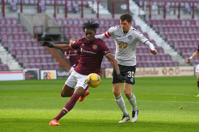 Hearts striker Armand Gnanduillet and Ayr United's Jack Baird in action at Tynecastle.