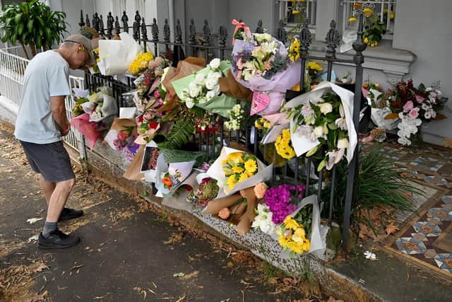 A man stands in front of floral tributes placed at the Paddington residence of Jesse Baird in Sydney, New South Wales, Australia. Picture: Bianca De Marchi/Shutterstock