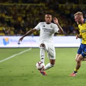 Eder Militao of Real Madrid controls the ball under pressure from Oli McBurnie.