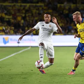 Eder Militao of Real Madrid controls the ball under pressure from Oli McBurnie.