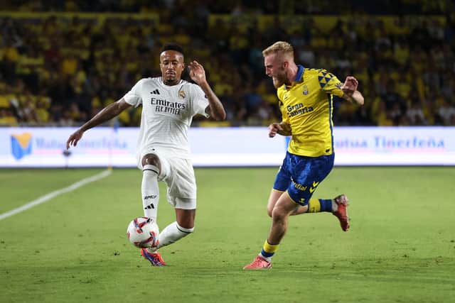 Eder Militao of Real Madrid controls the ball under pressure from Oli McBurnie.
