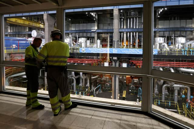 Workers survey the offline turbine hall in the UK’s last coal-fired power station (Picture: Darren Staples/AFP/Getty)