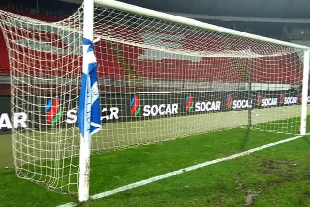 Home tie: Gordon was able to sneak on to the pitch after the final whistle to make sure his flag was tied to the posts
