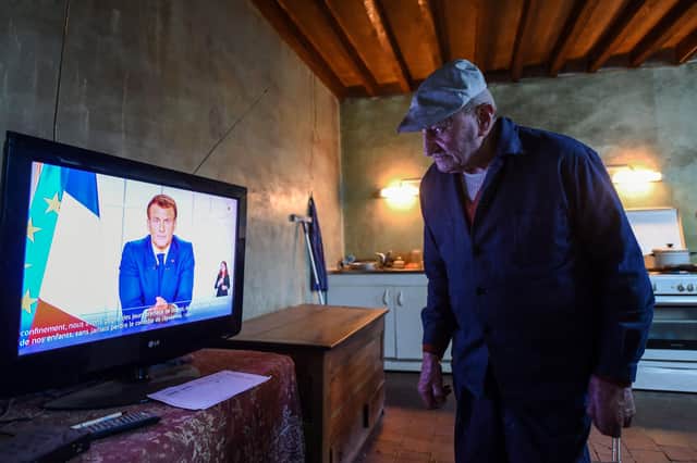 86-year-old retired farmer Henri Boutfol prepares his dinner as he  watches French President Emmanuel Macron's televised speech at his farm in Happonvilliers, near Chartres, eastern France, on March 31, 2021(Photo by JEAN-FRANCOIS MONIER/AFP via Getty Images).
