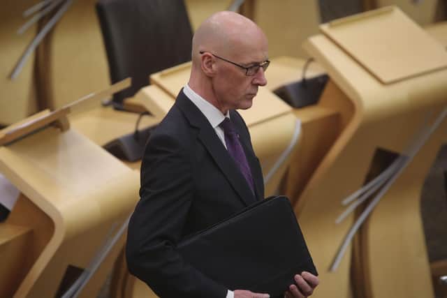 Deputy First Minister John Swinney outlined more than £500m in cuts to the Scottish budget in Holyrood.