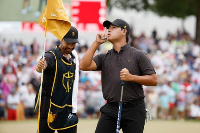 South Korea's Si Woo Kim silences the crowd after making a putt in his singles match against Justin Thomas in the concluding Presidents Cup session on Sunday. Picture: Jared C. Tilton/Getty Images.