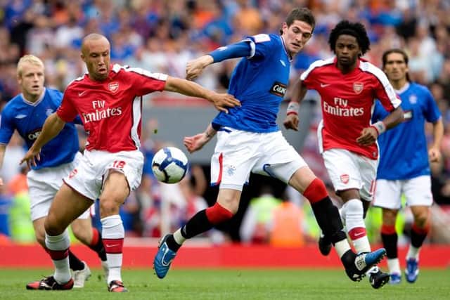 Mikael Silvestre and Rangers' Kyle Lafferty in action during the 2009 Emirates Challenge Cup (Picture: SNS Group Bill Murray)