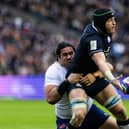 Scotland's Jack Dempsey offloads against France under pressure from Posolo Tuilagi. (Photo by Craig Williamson / SNS Group)