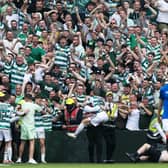 Celtic's players celebrate with fans after the big win over Rangers.