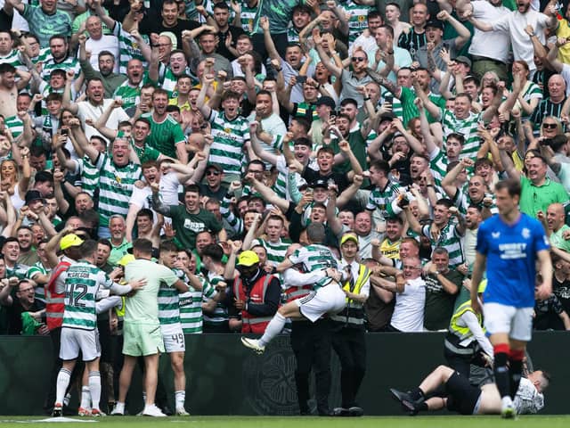 Celtic's players celebrate with fans after the big win over Rangers.