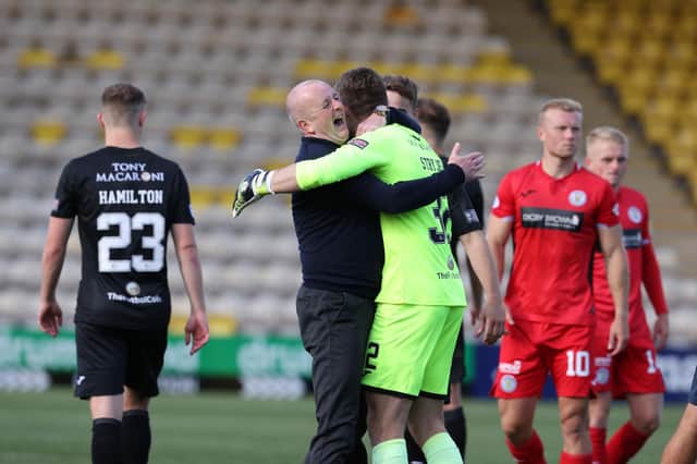 Livingston manager David Martindale celebrates with his goalkeeper Max Stryjek after the team booked a place in the League Cup quarter-finals. Photo by Alan Harvey / SNS Group