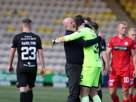 Livingston manager David Martindale celebrates with his goalkeeper Max Stryjek after the team booked a place in the League Cup quarter-finals. Photo by Alan Harvey / SNS Group