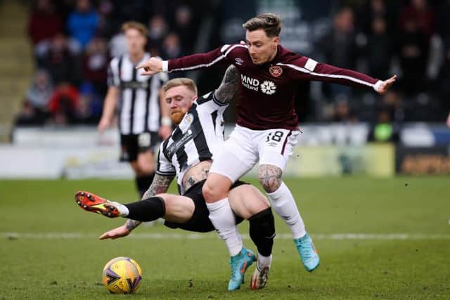 Alan Power (L) tackles Hearts' Barrie McKay.  (Photo by Alan Harvey / SNS Group)