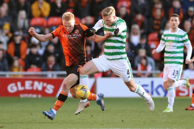 Dundee United's Ilmari Niskanen (left) battles with Celtic's Carl Starfelt. (Photo by Craig Williamson / SNS Group)