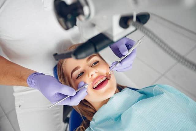 A patient undergoes a routine dental check-up with braces as part of orthodontic treatment.