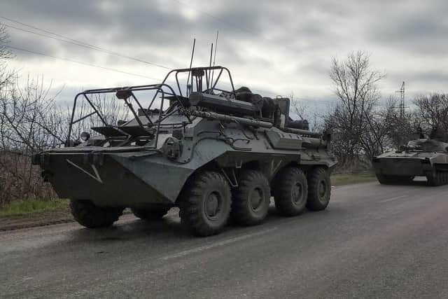 A Russian military convoy moves on a highway in an area controlled by Russian-backed separatist forces near Mariupol, Ukraine, Saturday, April 16, 2022. Mariupol, a strategic port on the Sea of Azov, has been besieged by Russian troops and forces from self-proclaimed separatist areas in eastern Ukraine for more than six weeks. (AP Photo/Alexei Alexandrov)