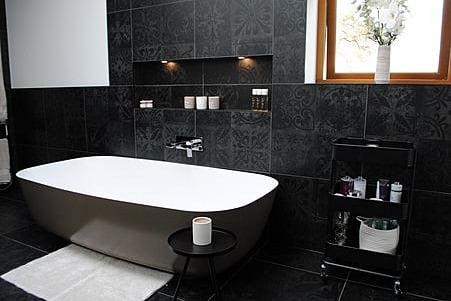 The stylish bathroom includes a luxurious free-standing bath.