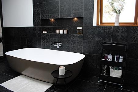 The stylish bathroom includes a luxurious free-standing bath.