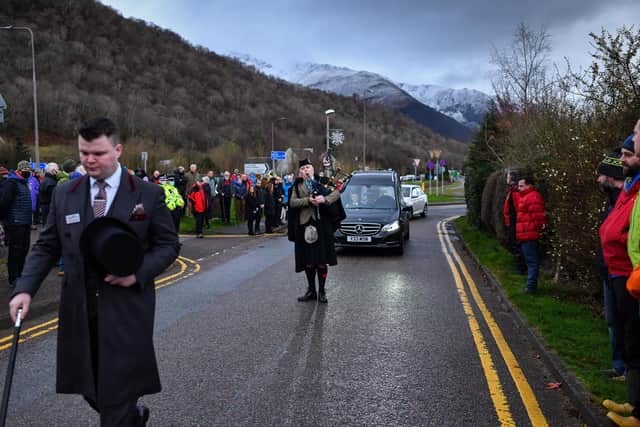 The funeral cortege makes its way through Glencoe