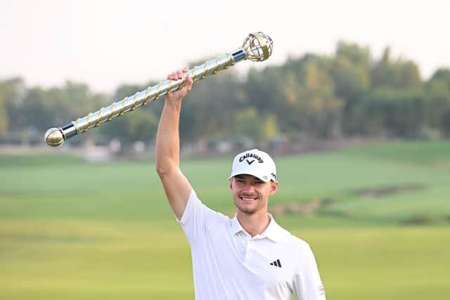 Dane Nicolai Hojgaard poses with the DP World Tour Championship trophy after his two-shot success at Jumeirah Golf Estates in Dubai. Picture: Ross Kinnaird/Getty Images.