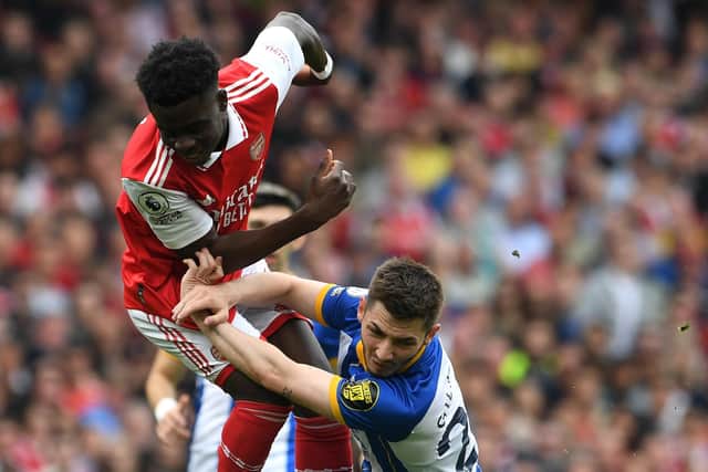 Bukayo Saka of Arsenal clashes with Billy Gilmour of Brighton & Hove Albion during the Premier League match between Arsenal FC and Brighton & Hove Albion at Emirates Stadium on May 14, 2023 in London, England. (Photo by David Price/Arsenal FC via Getty Images)