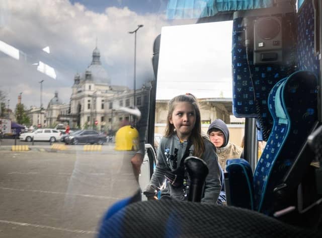 A young girl climbs aboard a bus bound for Przemyśl in Poland, carrying refugees from regions of Southern and Eastern Ukraine, including Mariupol.