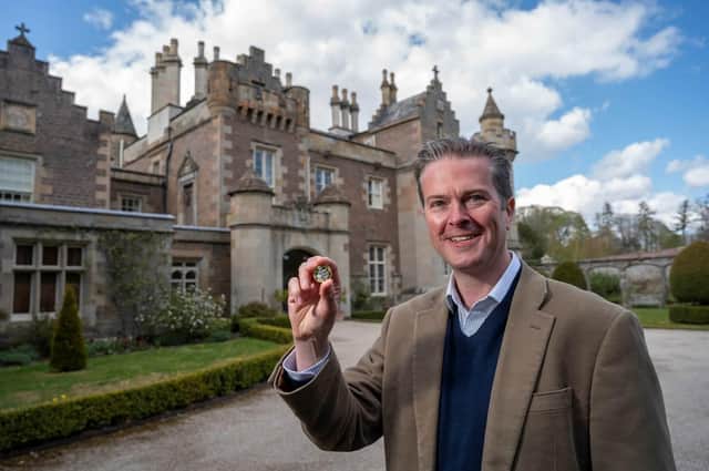 Matthew Maxwell Scott, the great, great, great, great grandson of Sir Walter Scott and trustee at Abbotsford with the new coin (Photo: Royal Mint).