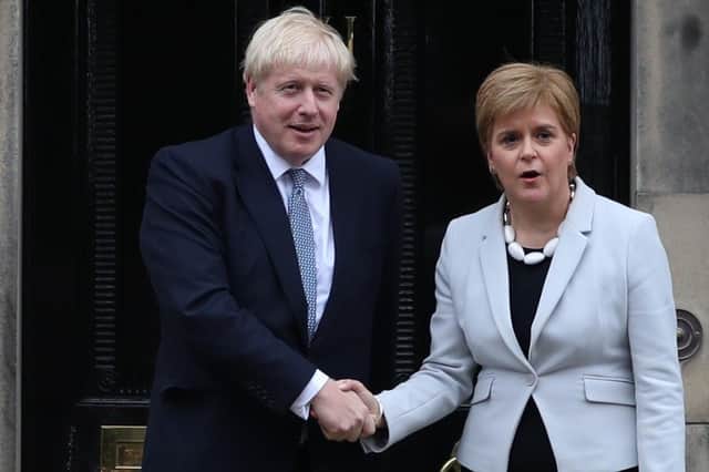First Minister Nicola Sturgeon welcomes Prime Minister Boris Johnson outside Bute House in last year