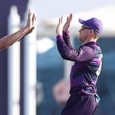 Scotland's cricketers celebrate their win against Papua New Guinea - one more celebration will guarantee a place in the 'Super 12' stage (Photo by HAITHAM AL-SHUKAIRI/AFP via Getty Images)