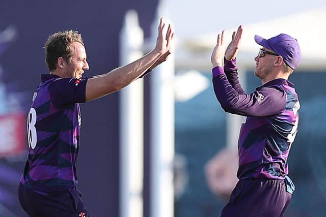 Scotland's cricketers celebrate their win against Papua New Guinea - one more celebration will guarantee a place in the 'Super 12' stage (Photo by HAITHAM AL-SHUKAIRI/AFP via Getty Images)