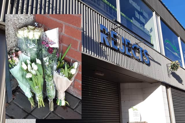 Flowers have been left at the entrance to the store