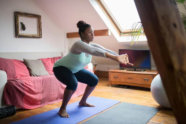 Woman performing squats in home workout
