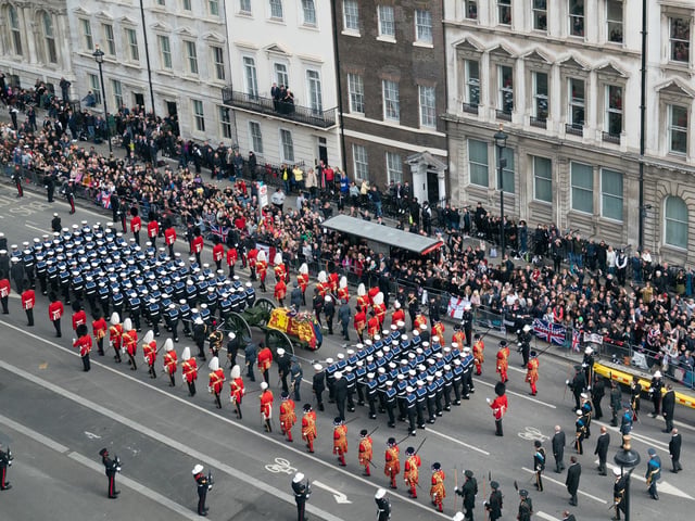 The State Gun Carriage carries the coffin of Queen Elizabeth II, draped in the Royal Standard with the Imperial State Crown and the Sovereign's orb and sceptre, as it leaves Westminster Abbey after the State Funeral of the Queen. Picture date: Monday September 19, 2022.