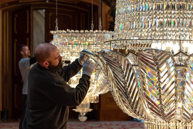 Gloves are worn to protect the chandeliers from the effects of skin oils.