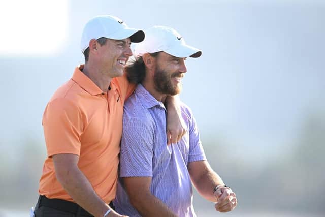 Rory McIlroy gives Tommy Fleetwood a hug as they walk off the 18th green at Dubai Creek Golf and Yacht Club. Picture: Alex Burstow/Getty Images.
