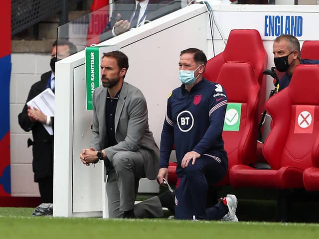 England's manager Gareth Southgate and  Steve Holland, assistant coach of England, 'take a knee'. Picture: Getty Images