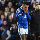 Rangers defender Connor Goldson leaves the pitch in pain during the match against Liverpool.