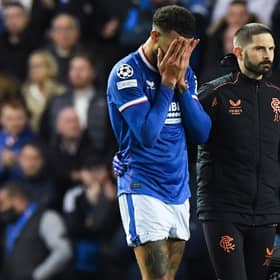 Rangers defender Connor Goldson leaves the pitch in pain during the match against Liverpool.