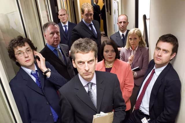 Scanlan in BBC's hit comedy The Thick of it with l-r: Ollie (Chris Addison), Glenn (James Smith), Julius (Alex MacQueen), Malcolm Tucker (Peter Capaldi), Ben Swain (Justin Edwards), Terri (Joanna Scanlan), Nick Hanway (Martin Savage), Robyn (Polly Kemp), and Jamie (Paul Higgins).