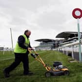The world famous finish line for the Grand National being cut by Aintree Ground staff.