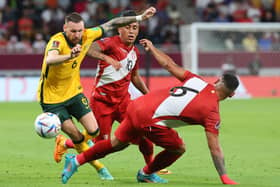 Australia's forward Martin Boyle (L) is tackled by Peru's defender Miguel Trauco (R) during the FIFA World Cup 2022 inter-confederation play-offs match between Australia and Peru. (Photo by KARIM JAAFAR / AFP) (Photo by KARIM JAAFAR/AFP via Getty Images)