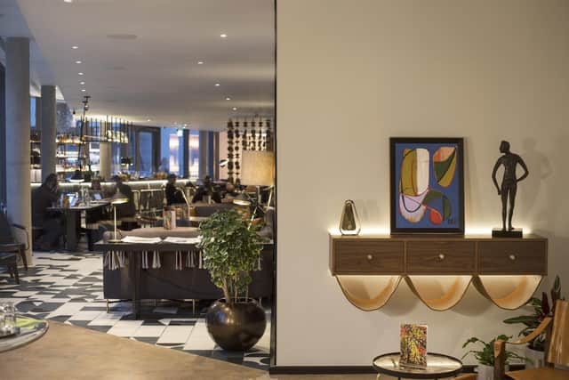 Handpicked furniture and eclectic artwork help the lobby feel like home
