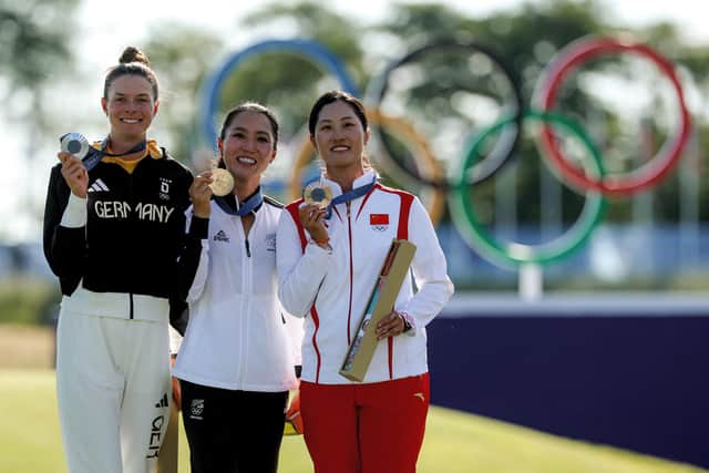 Gold medallist Lydia Ko, centre, flanked by silver medallist Esther Henseleit, left, and bronze medallist Lin Xiyu at Le Golf National in France on Saturday. Picture: EMMANUEL DUNAND/AFP via Getty Images.